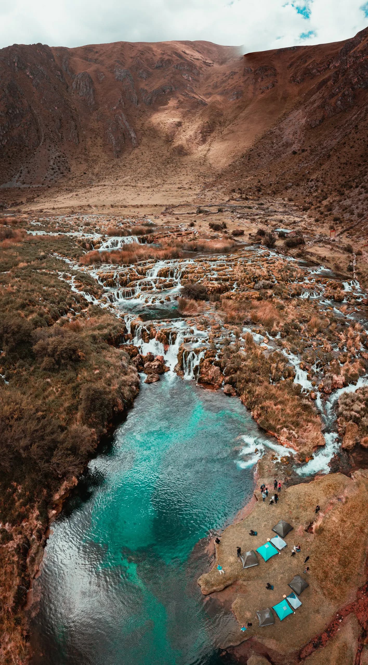 © Lyon Peru · Pexels Elevated view of the waterfalls and turquoise pools of Huancaya